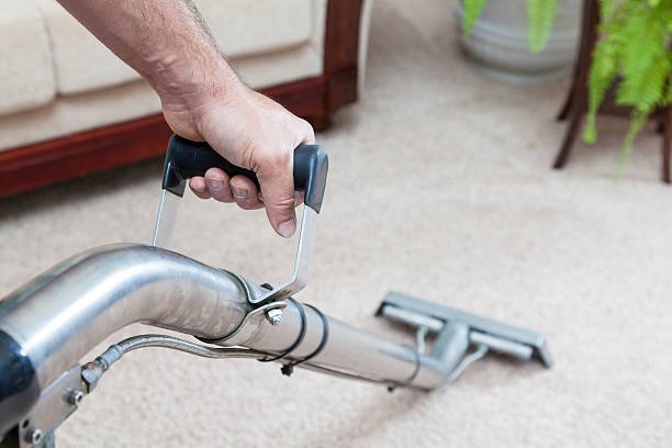 Man cleaning carpets in home - Gleamers Cleaning